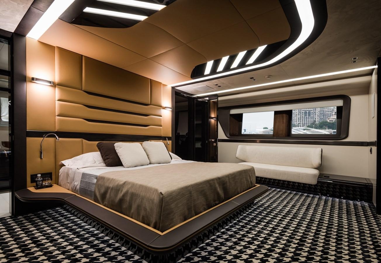 a room with a bed and a couch aboard DYNAMIQ GTT 115  Yacht for Sale