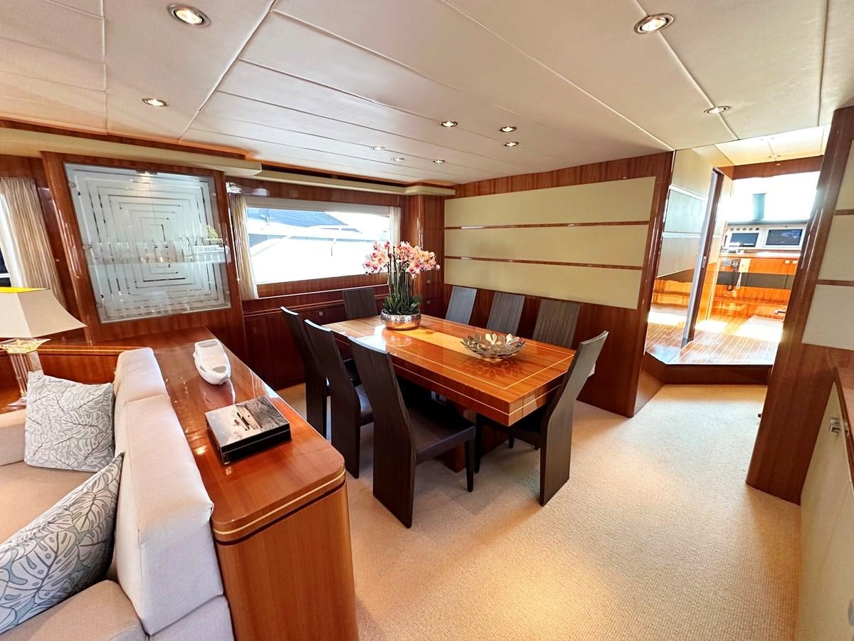 a room with a table and couches aboard ESPRESSO Yacht for Sale
