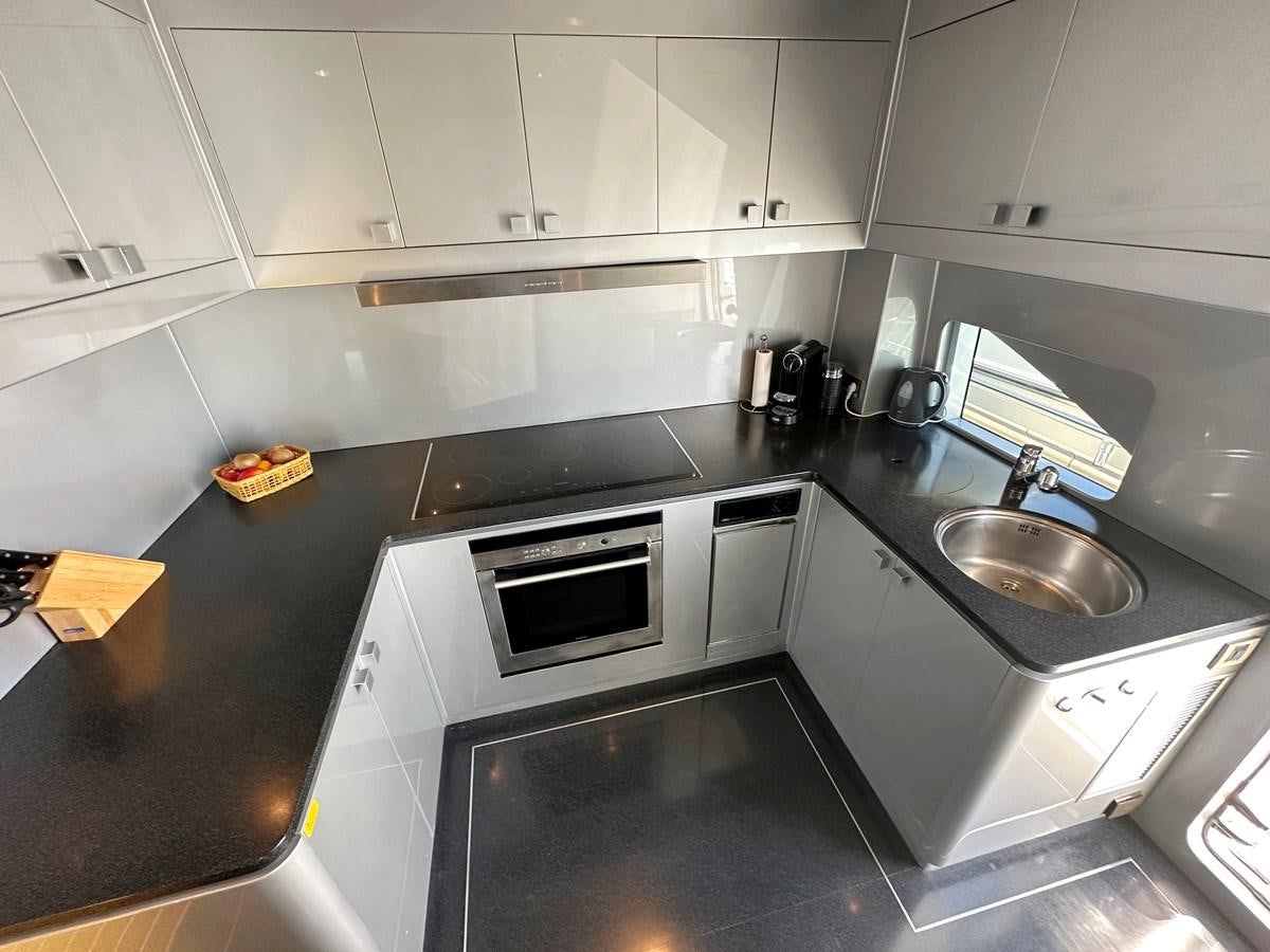 a kitchen with white cabinets aboard ESPRESSO Yacht for Sale