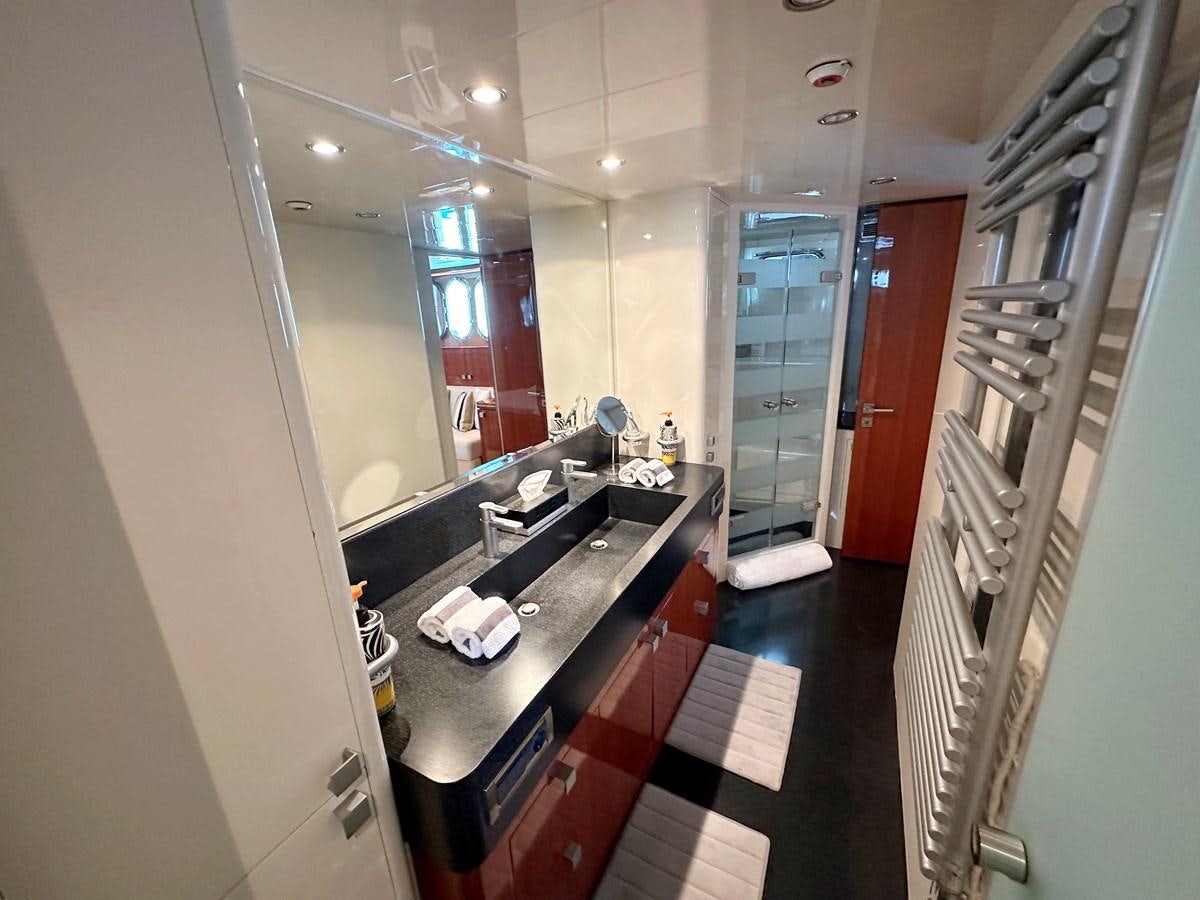 a bathroom with a countertop sink and a mirror aboard ESPRESSO Yacht for Sale