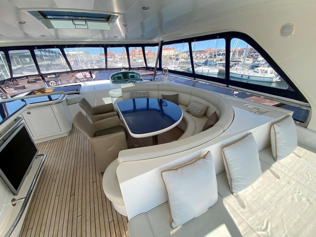 a room with a couch and a table with chairs aboard MARACAIBO Yacht for Sale