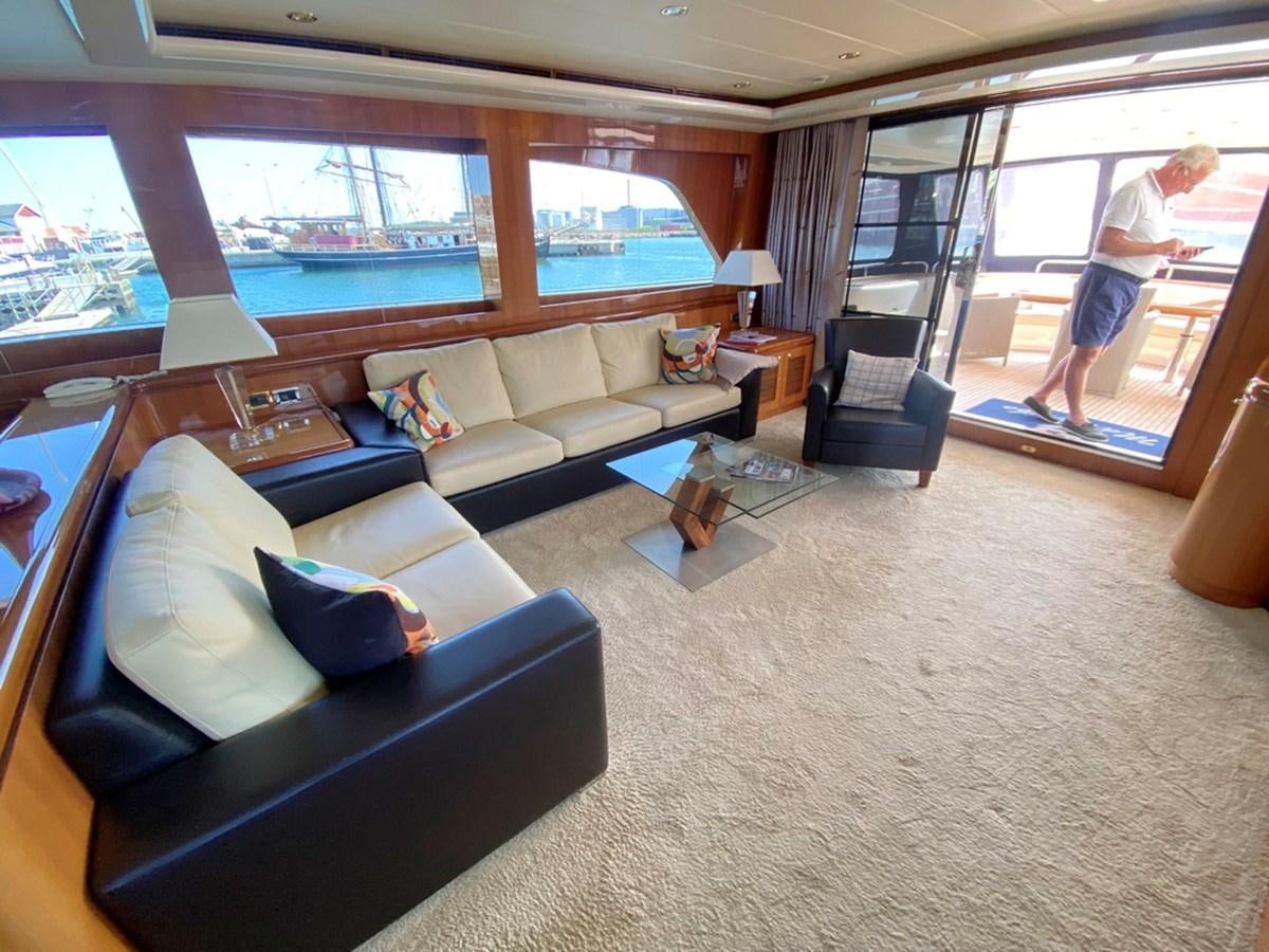 a living room with a large window aboard MARACAIBO Yacht for Sale