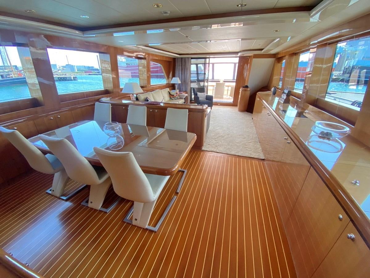 a room with a table chairs and a window aboard MARACAIBO Yacht for Sale