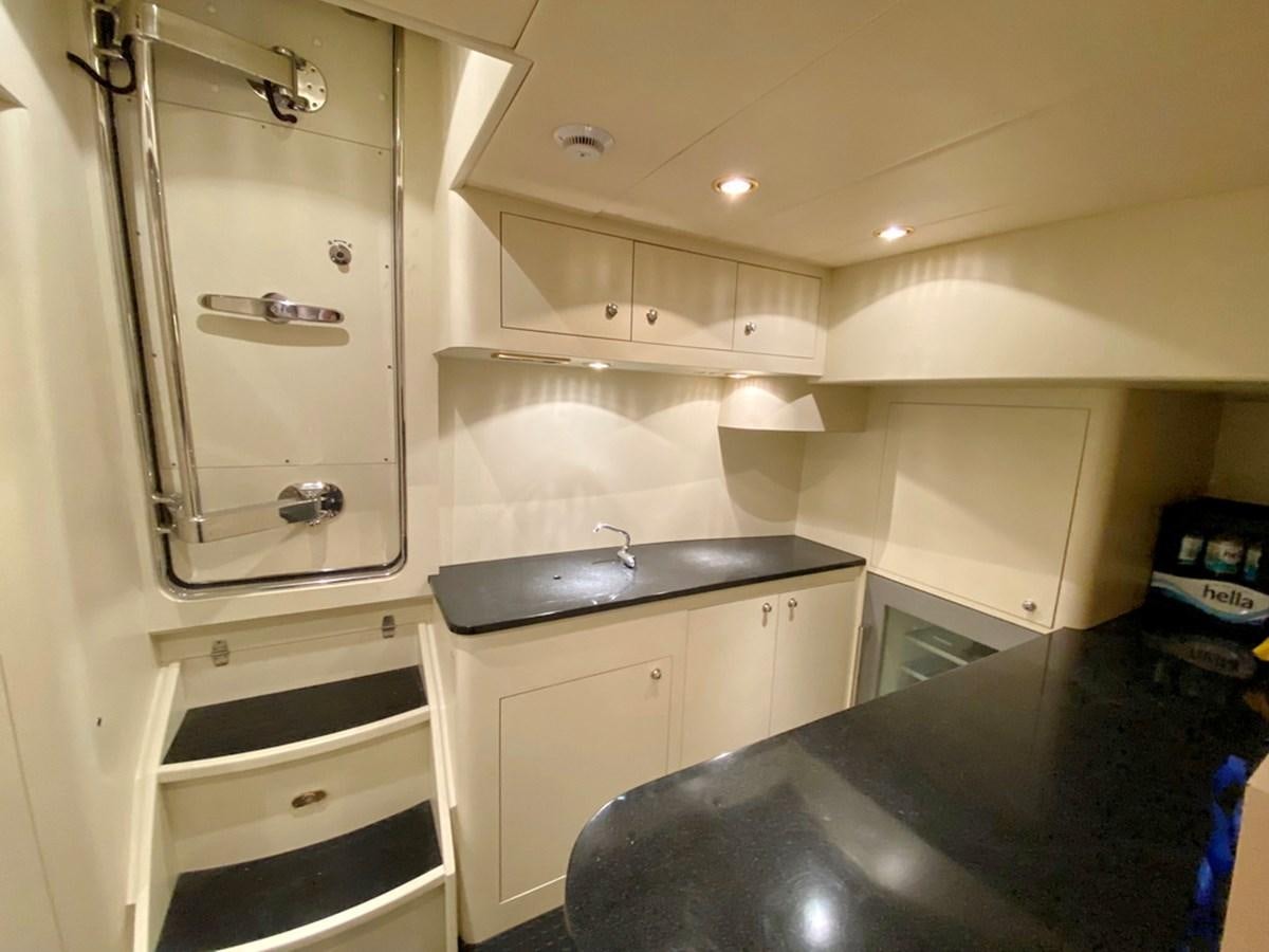 a kitchen with a sink and a ladder aboard MARACAIBO Yacht for Sale