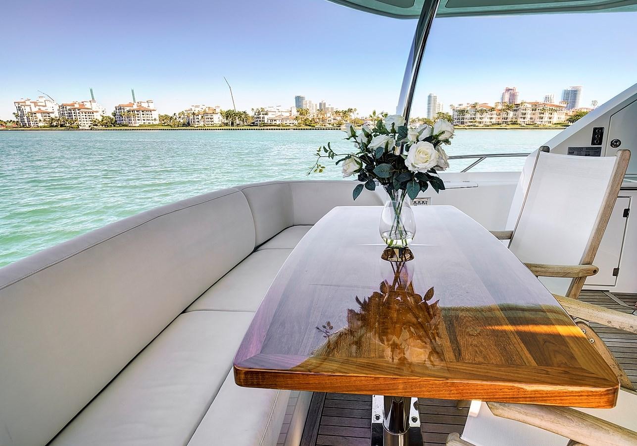 a table with white flowers on it aboard MISTY K Yacht for Sale