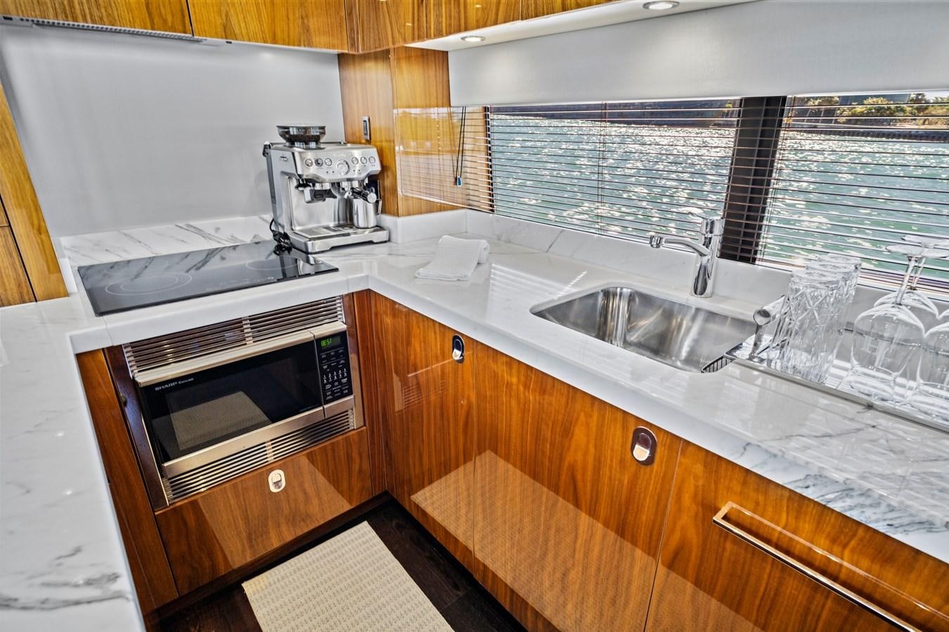 a kitchen with a microwave oven and sink aboard MISTY K Yacht for Sale