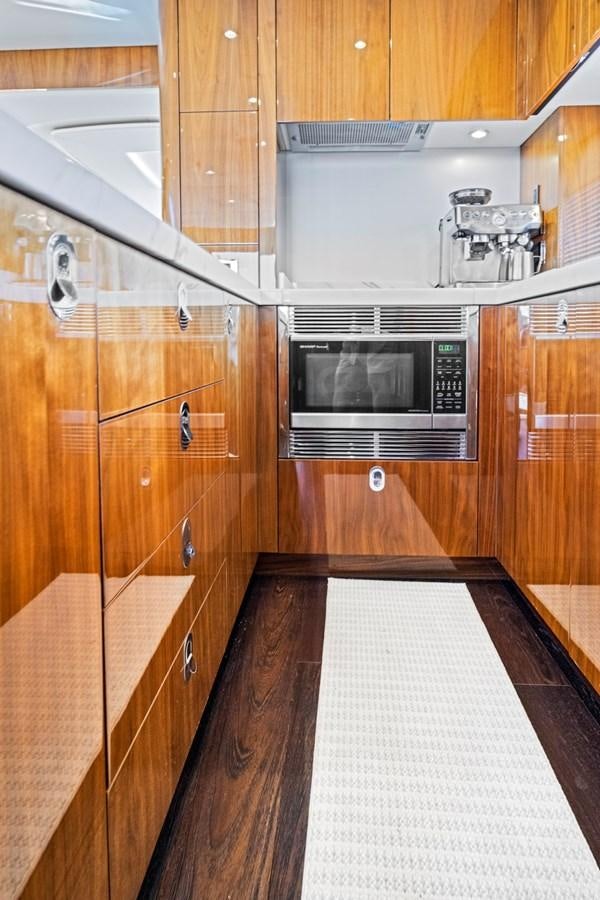 a kitchen with wooden cabinets aboard MISTY K Yacht for Sale