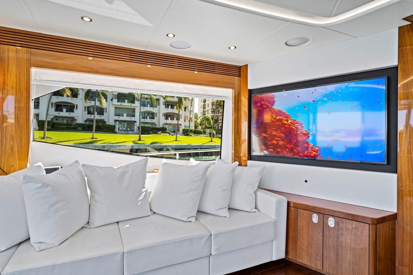 a room with a large television and a white sofa aboard MISTY K Yacht for Sale