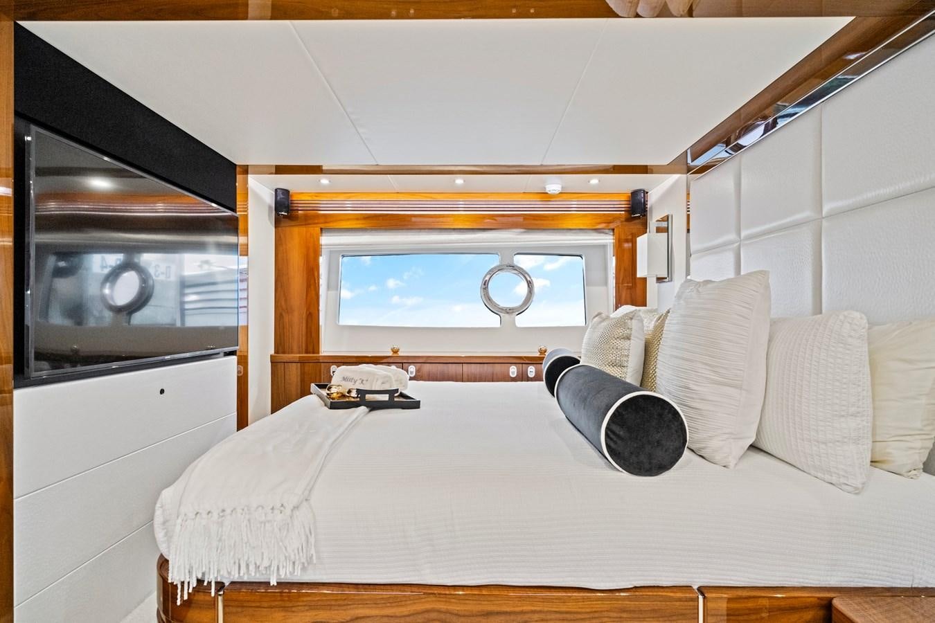 a bed with a white bed spread aboard MISTY K Yacht for Sale