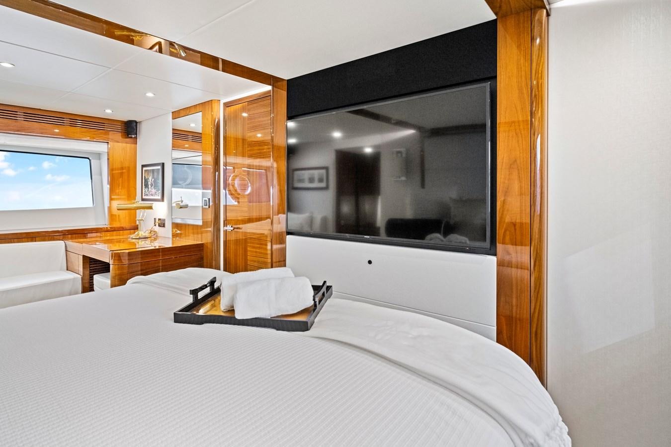 a bedroom with a large mirror aboard MISTY K Yacht for Sale