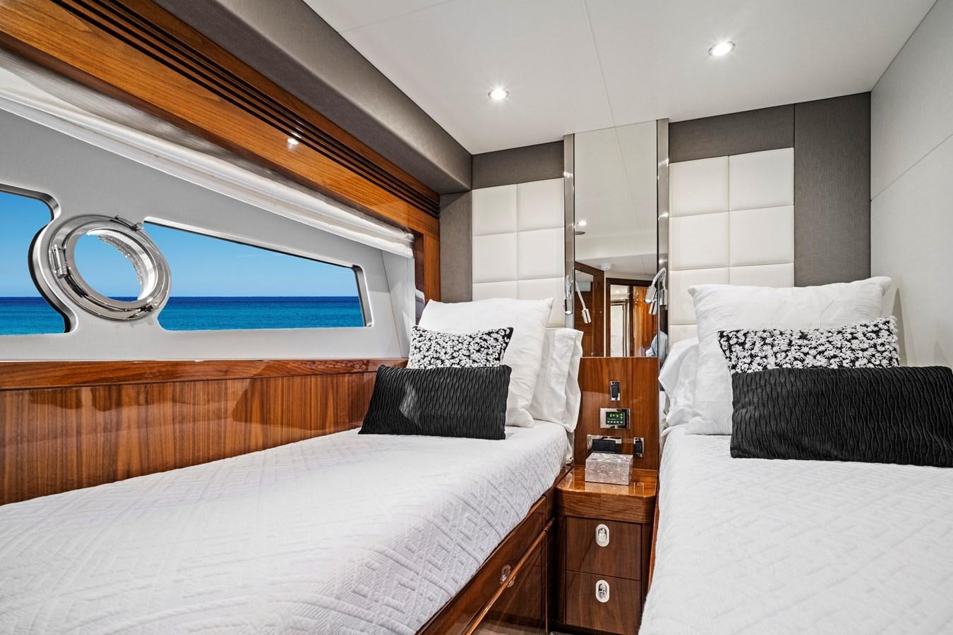 a room with a bed and a mirror aboard MISTY K Yacht for Sale