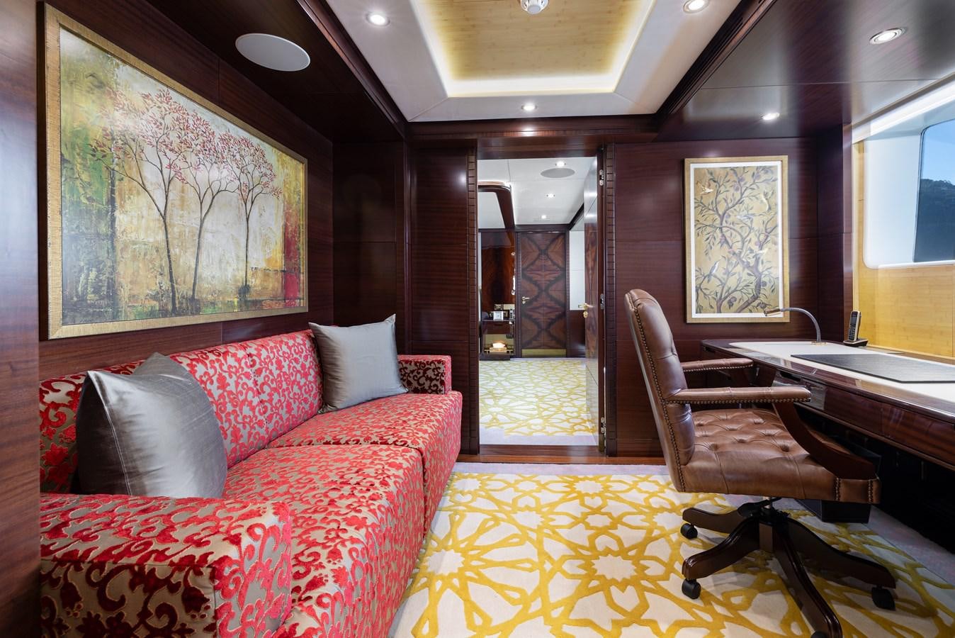 a living room with a red couch aboard LADY TAHITI Yacht for Sale