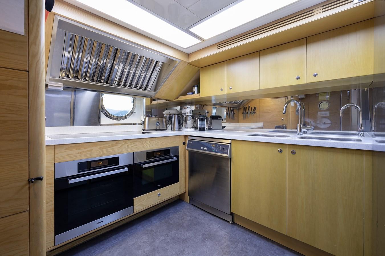 a kitchen with a stove and oven aboard LADY TAHITI Yacht for Sale