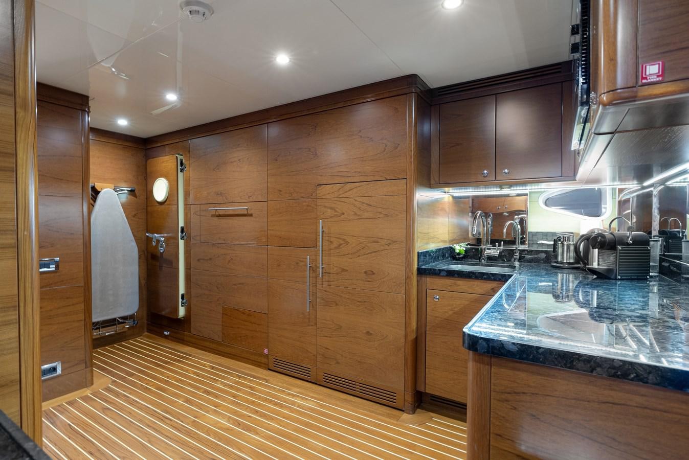a kitchen with wooden cabinets aboard LADY TAHITI Yacht for Sale