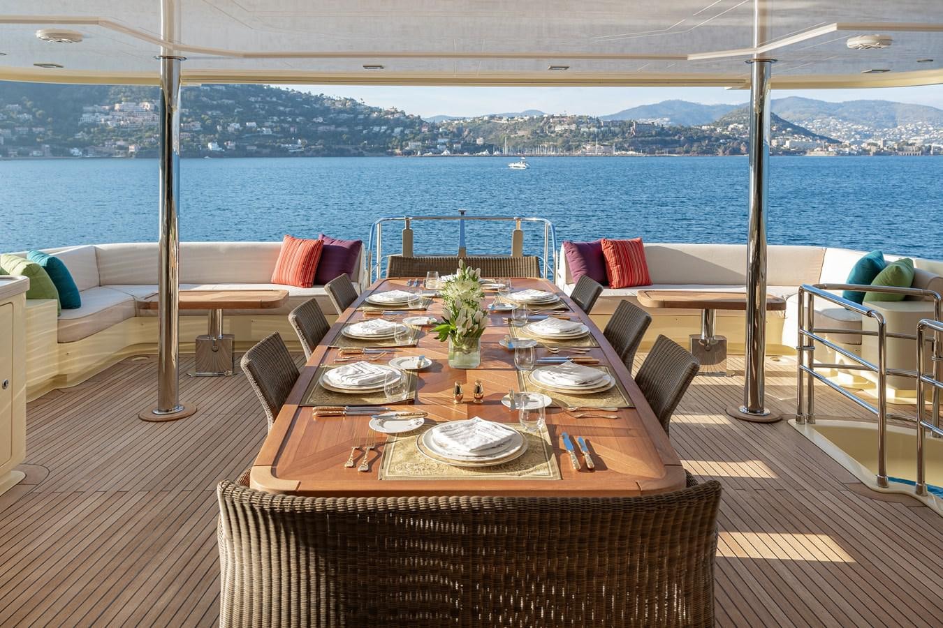 a table set for a meal on a balcony overlooking the ocean aboard LADY TAHITI Yacht for Sale