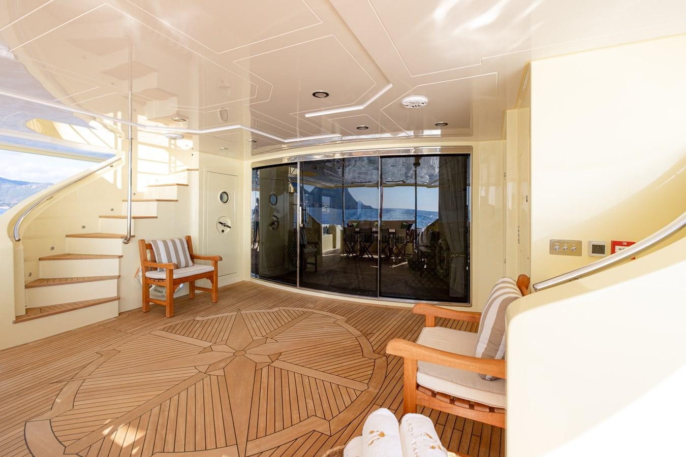 a room with a wood floor and a large window with a wood floor aboard LADY TAHITI Yacht for Sale