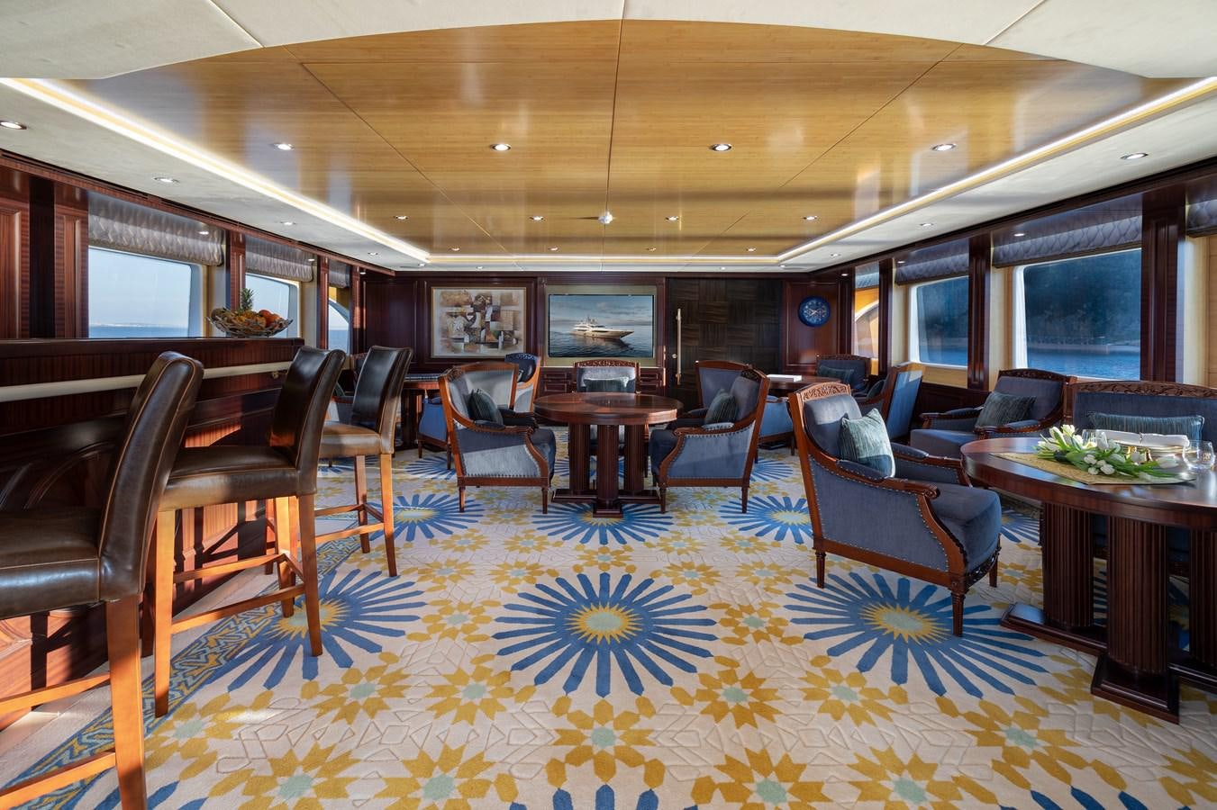 a room with a table chairs and a large window aboard LADY TAHITI Yacht for Sale