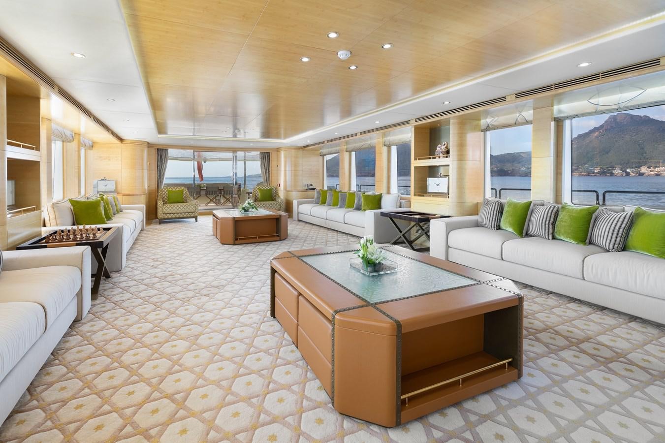 a living room with a table and couches aboard LADY TAHITI Yacht for Sale