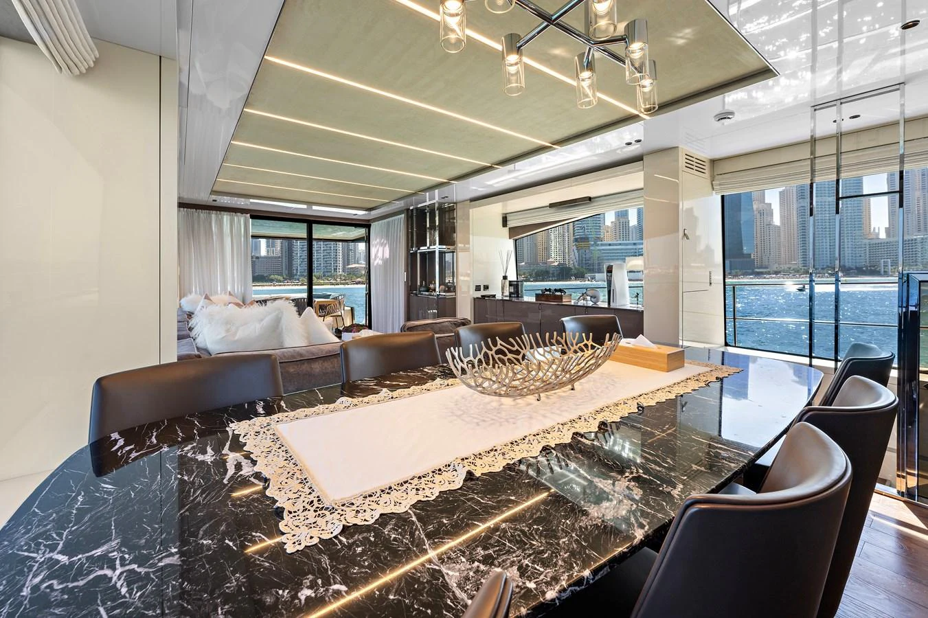 a living room with a large table aboard MOSHE Yacht for Sale