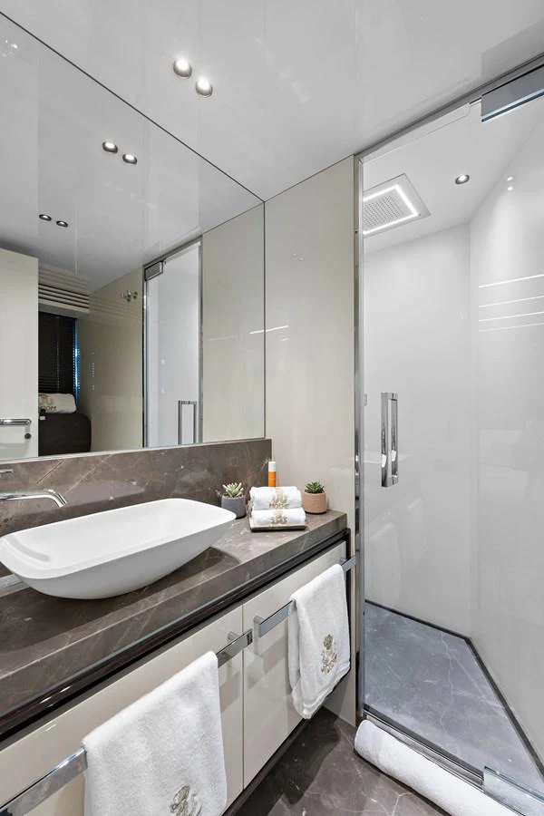 a bathroom with a large mirror aboard MOSHE Yacht for Sale