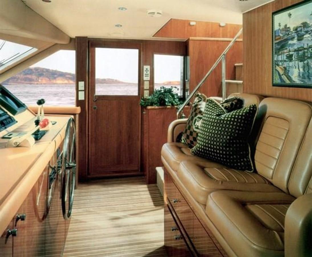 a boat with a table and chairs aboard VITA BREVIS Yacht for Sale