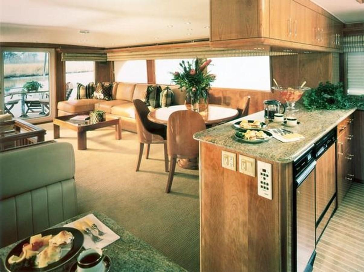 a kitchen with a dining table aboard VITA BREVIS Yacht for Sale