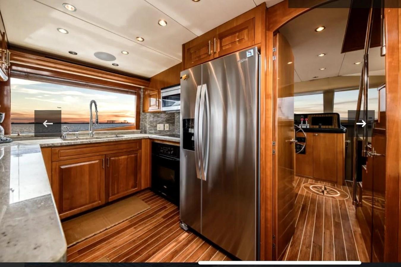a kitchen with a stainless steel refrigerator aboard VITA BREVIS Yacht for Sale
