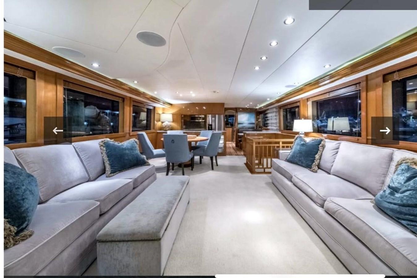 a living room with couches and a television aboard VITA BREVIS Yacht for Sale