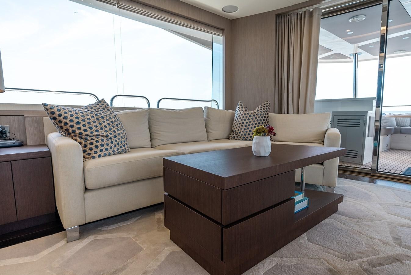 a living room with a couch and a coffee table aboard F5 Yacht for Sale