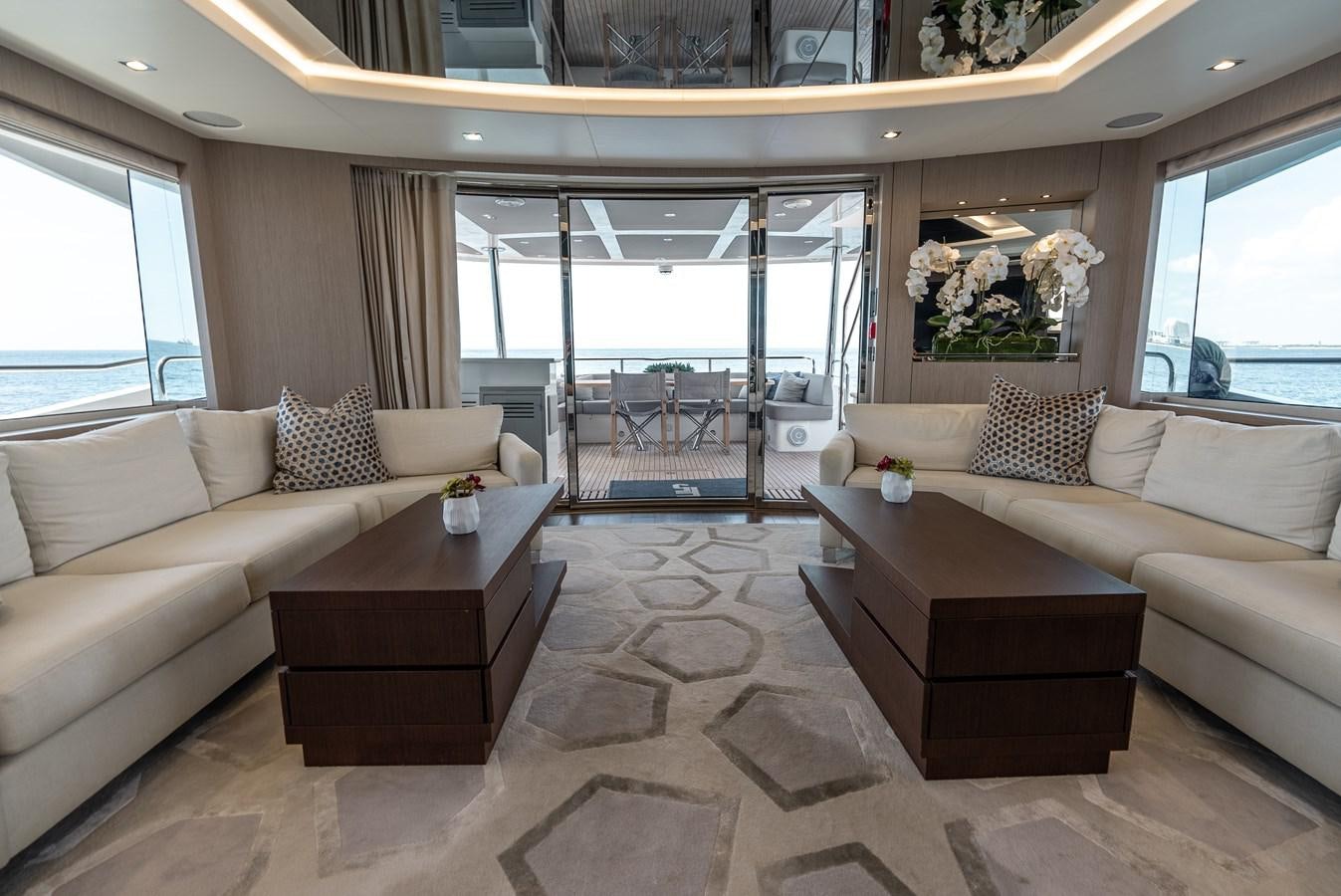a living room with a couch and a coffee table aboard F5 Yacht for Sale