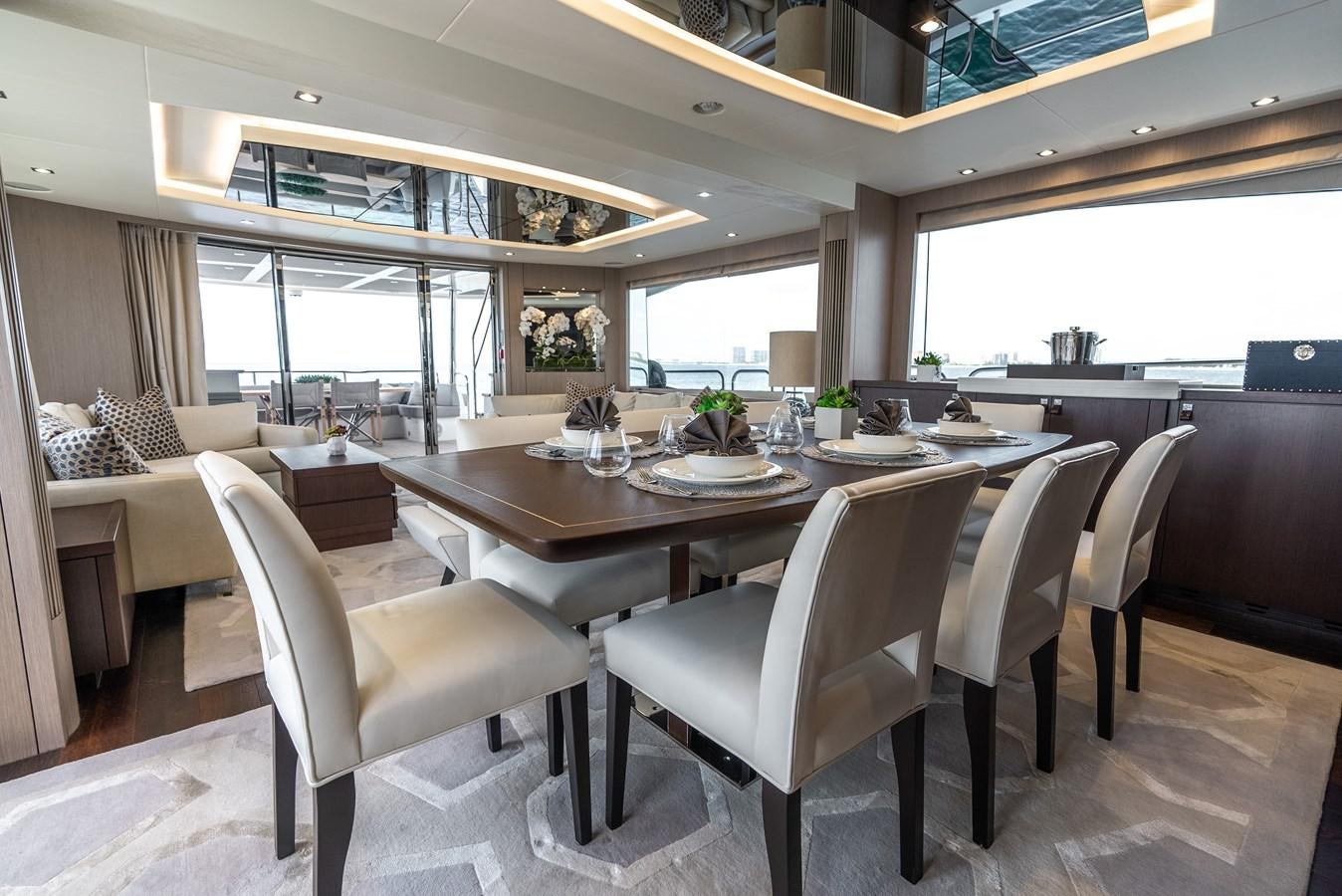 a large dining table with chairs aboard F5 Yacht for Sale