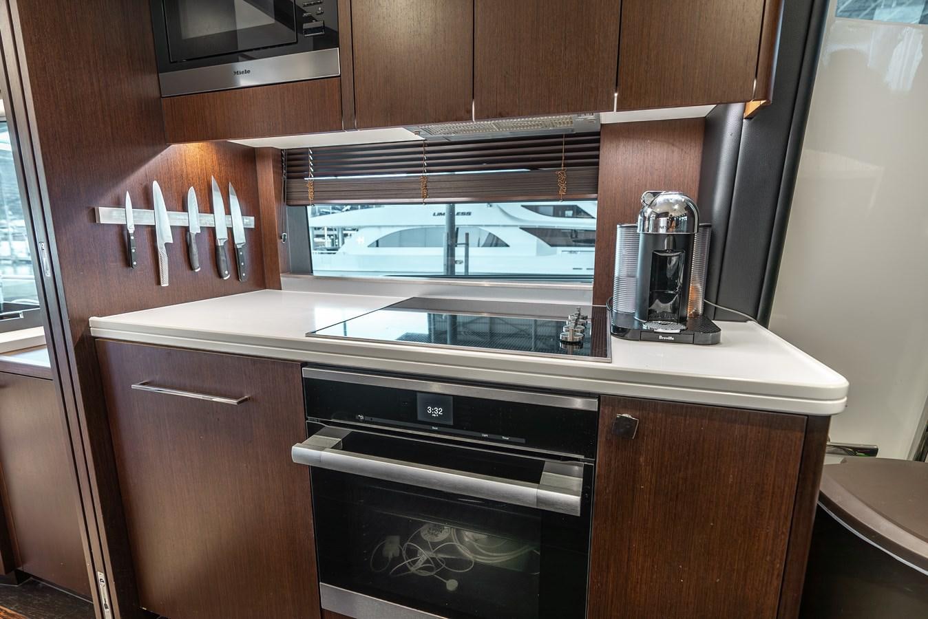 a kitchen with wooden cabinets aboard F5 Yacht for Sale