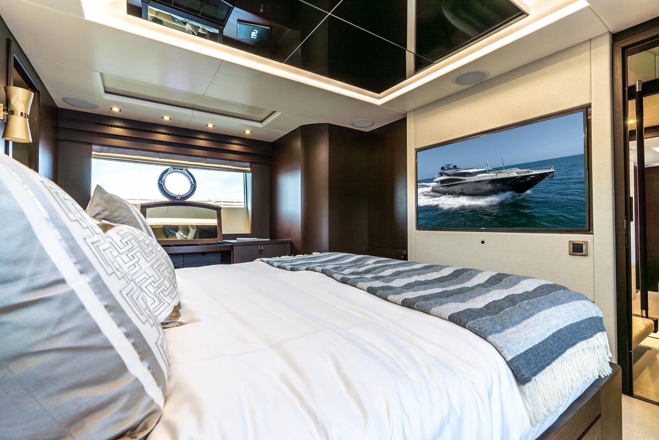 a bedroom with a bed and a television aboard F5 Yacht for Sale