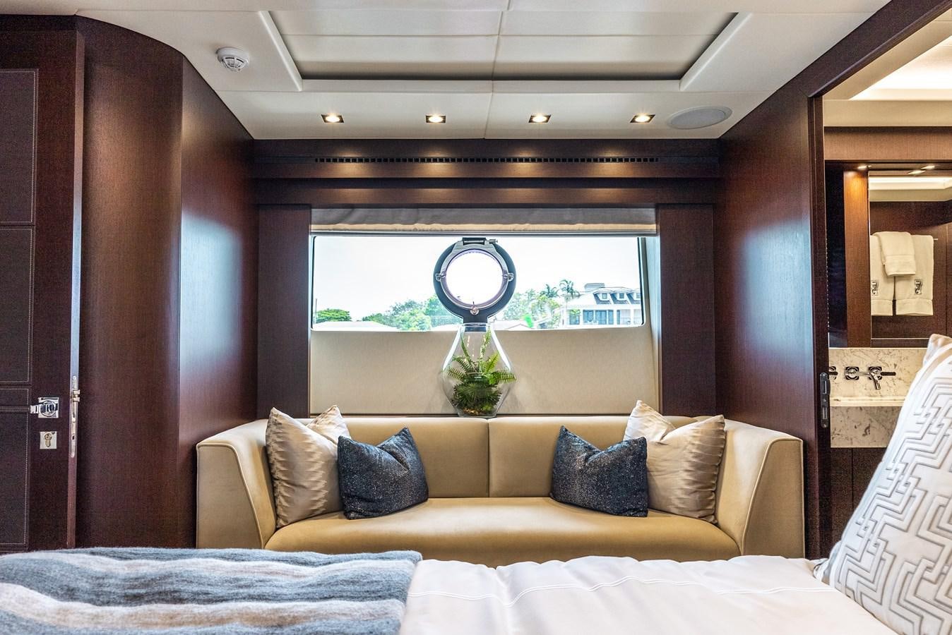 a room with a couch and a window aboard F5 Yacht for Sale