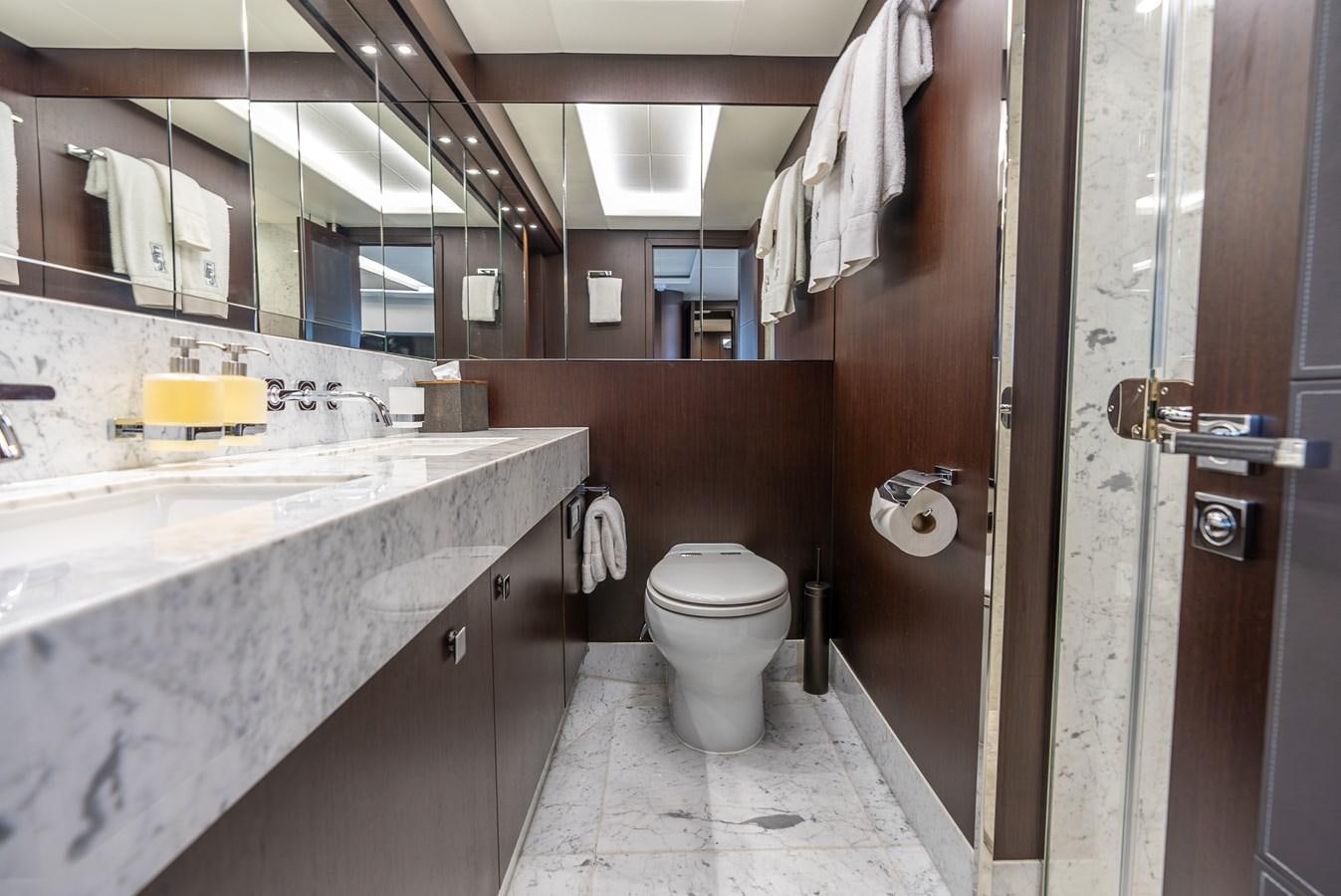 a bathroom with a sink toilet and a mirror aboard F5 Yacht for Sale