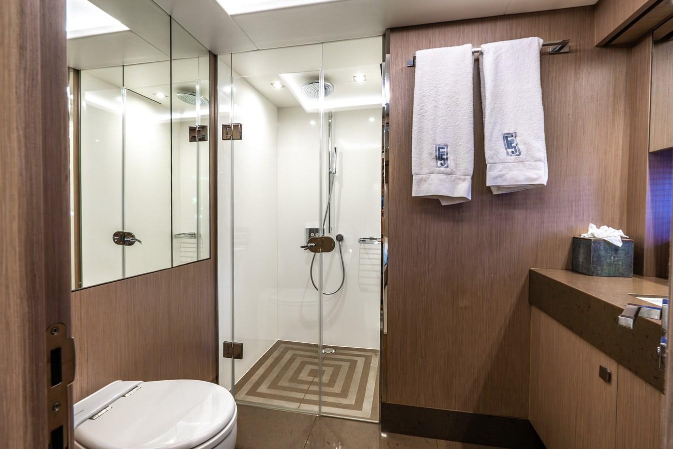 a bathroom with a shower unit and a toilet aboard F5 Yacht for Sale
