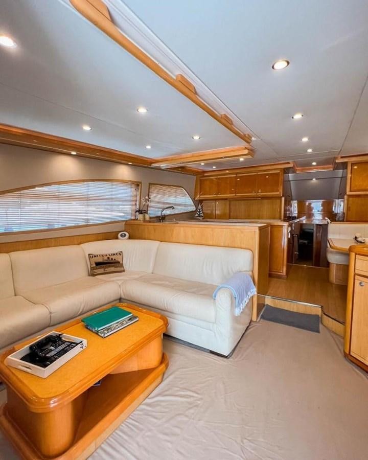 a living room with a couch and a table aboard BERTRAM 66 Yacht for Sale