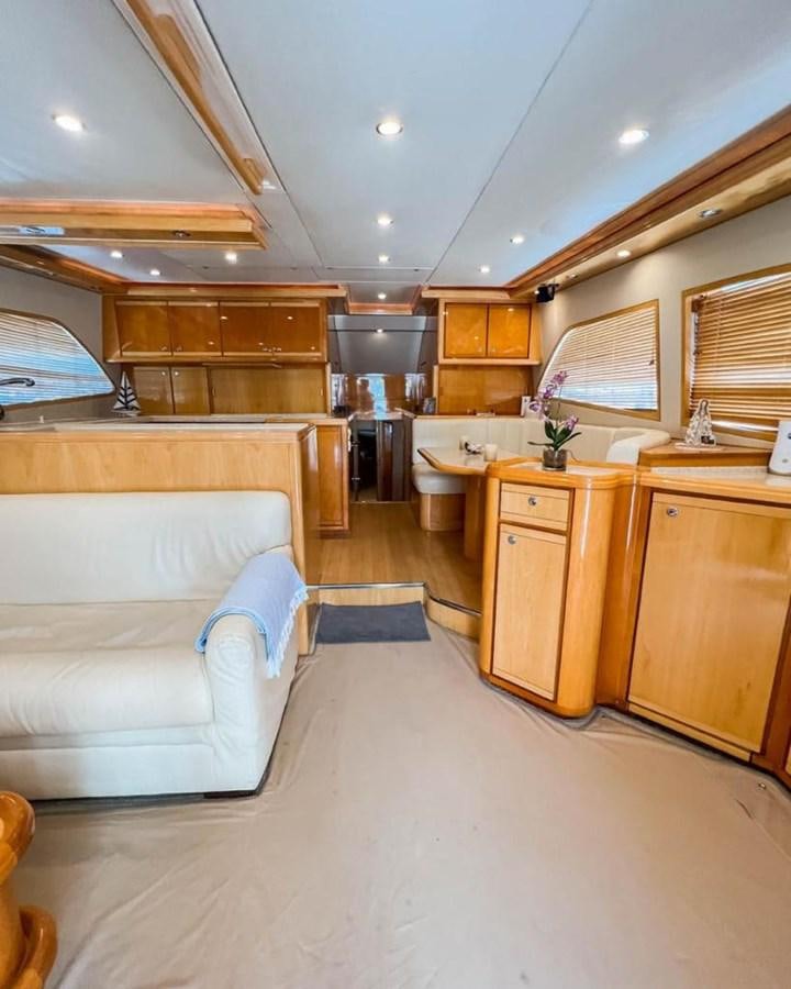 a living room with a couch and a table aboard BERTRAM 66 Yacht for Sale