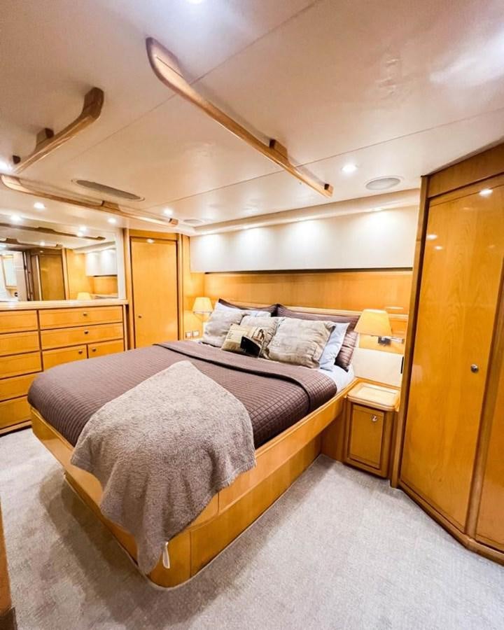 a large bedroom with a large bed aboard BERTRAM 66 Yacht for Sale