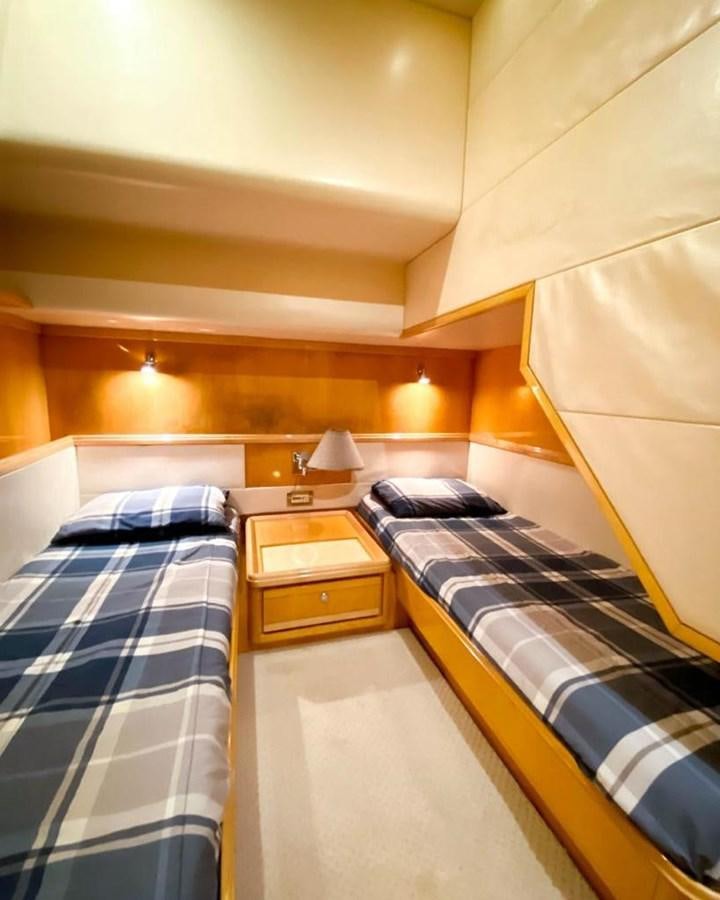 a room with two beds aboard BERTRAM 66 Yacht for Sale