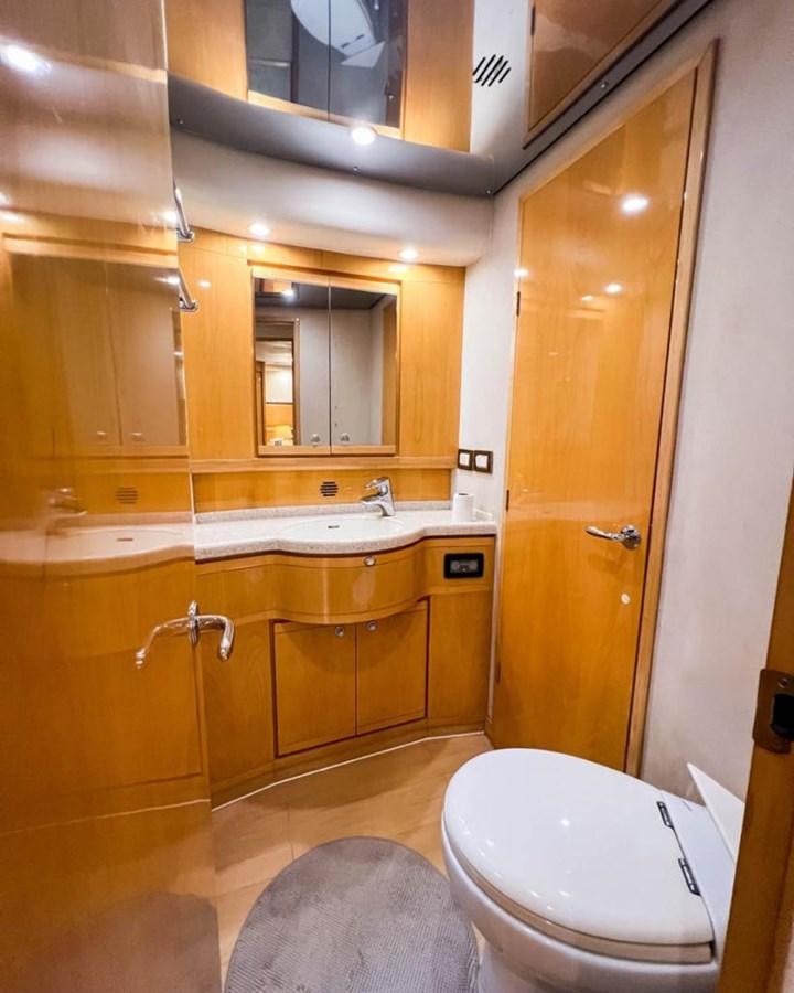 a bathroom with a toilet and sink aboard BERTRAM 66 Yacht for Sale