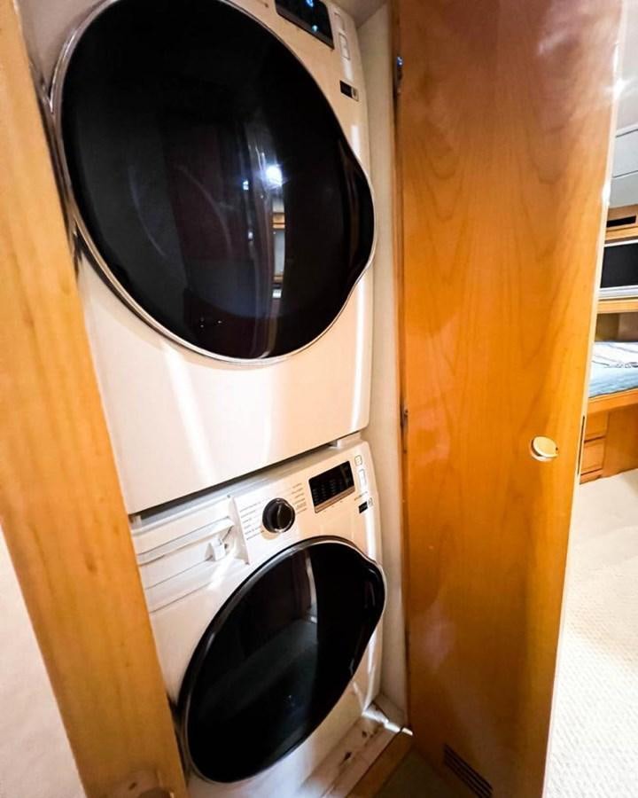 a washing machine in a room aboard BERTRAM 66 Yacht for Sale