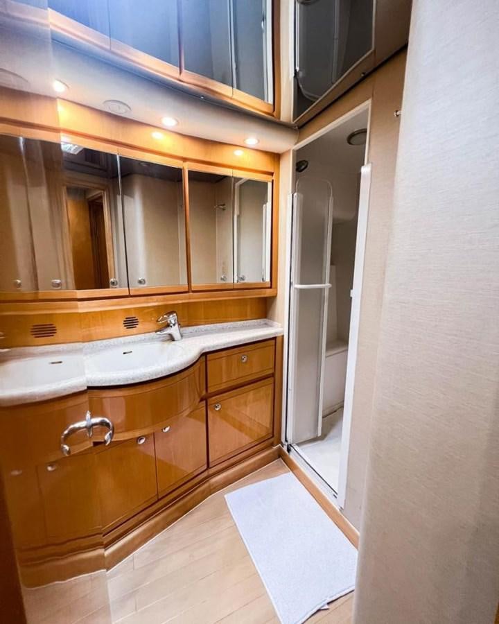 a bathroom with a large mirror aboard BERTRAM 66 Yacht for Sale
