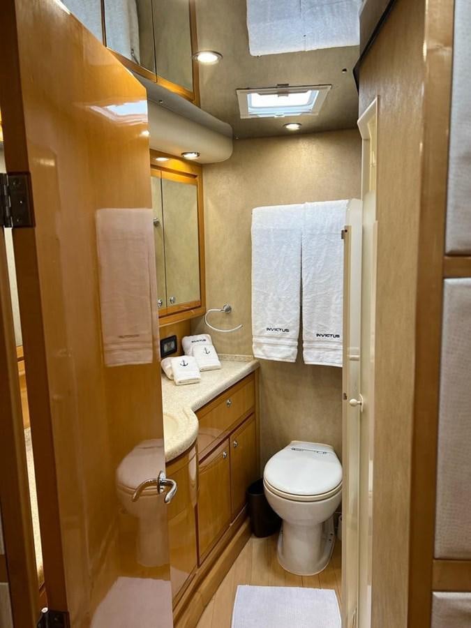 a bathroom with a toilet and towels aboard BERTRAM 66 Yacht for Sale
