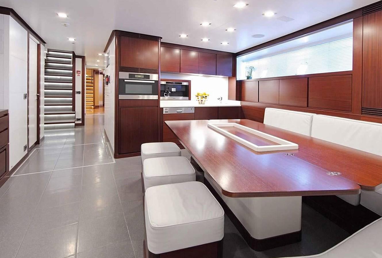 a large kitchen with a table and chairs aboard ARMADA Yacht for Sale