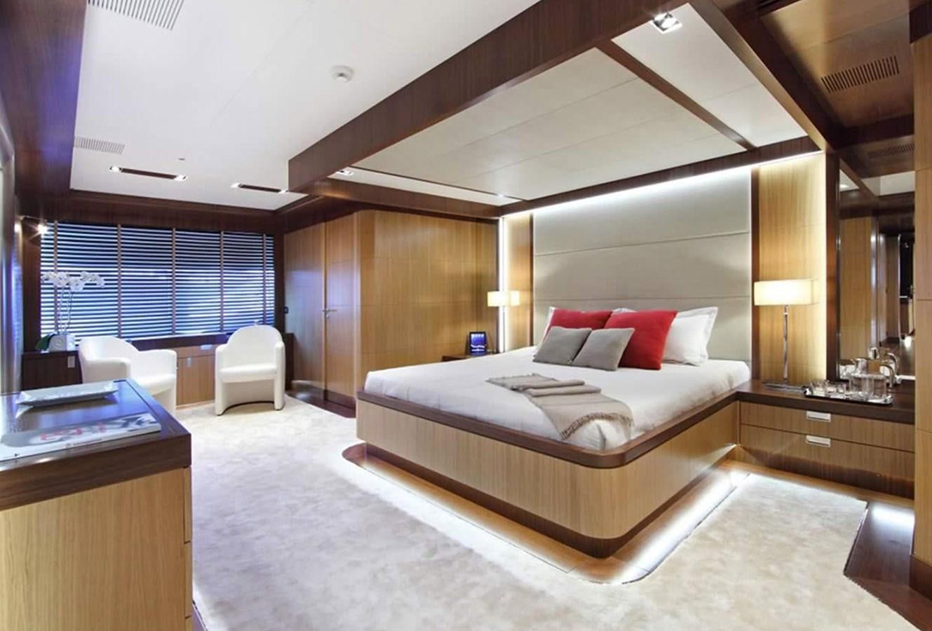 a bedroom with a bed and a desk aboard ARMADA Yacht for Sale