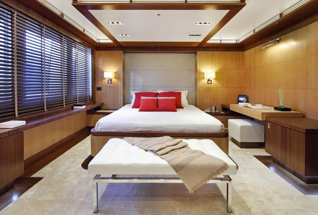 a room with a bed and desk aboard ARMADA Yacht for Sale