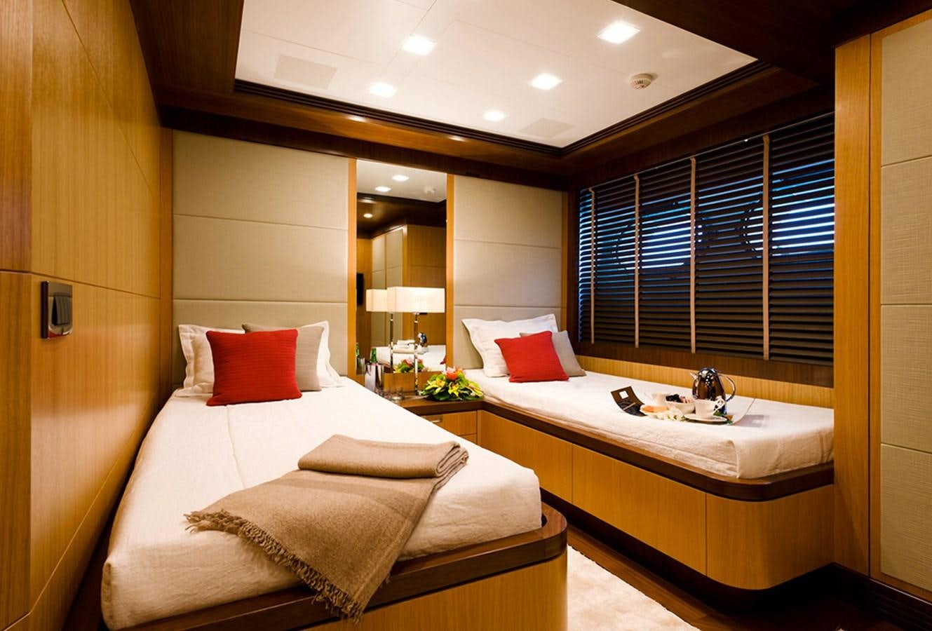 a hotel room with a bed and a mirror aboard ARMADA Yacht for Sale