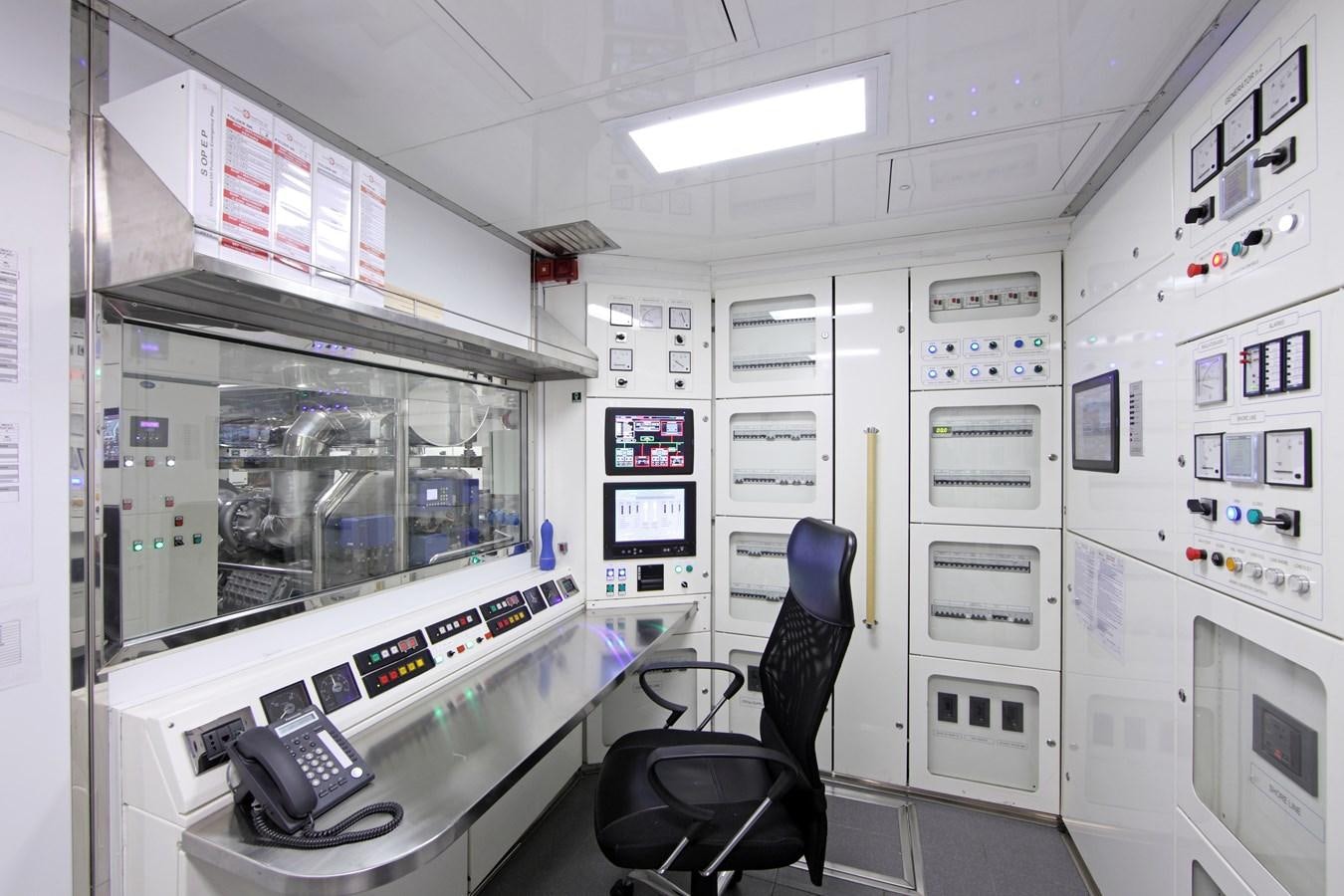 a person sitting in a chair in a control room aboard ARMADA Yacht for Sale