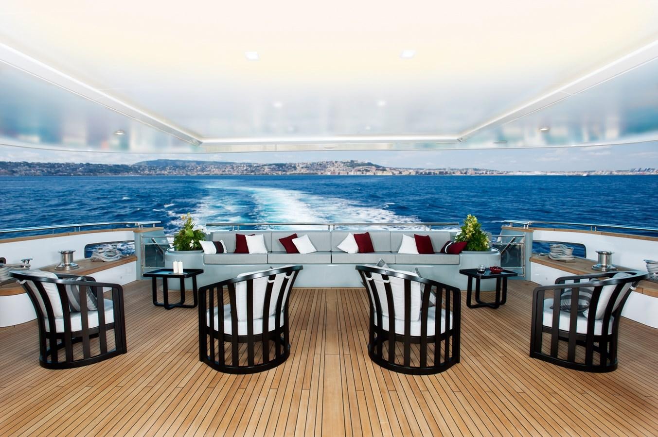 a room with a table chairs and a view of the ocean aboard ARMADA Yacht for Sale